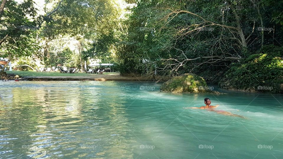 Young lady swimming in the White river, Jamaica