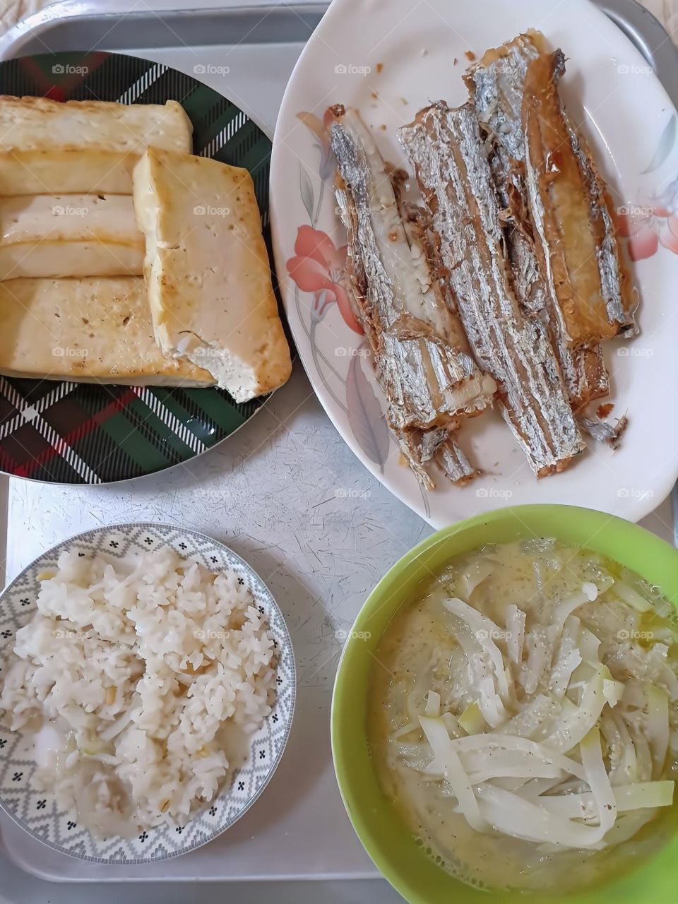 simple yet nutritious food. fried tofu, fried fish, rice  and radish soup.