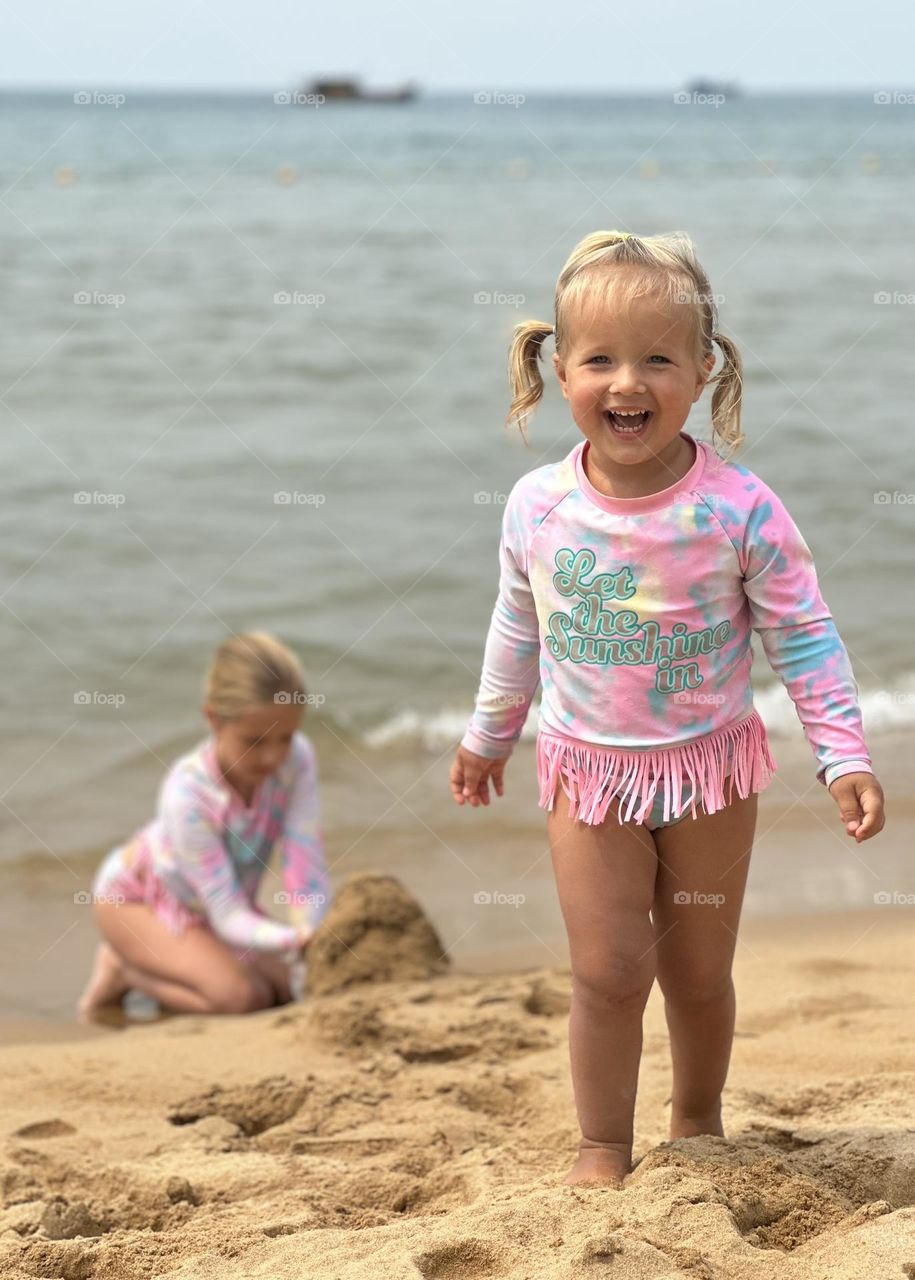 Cute baby girls on beach