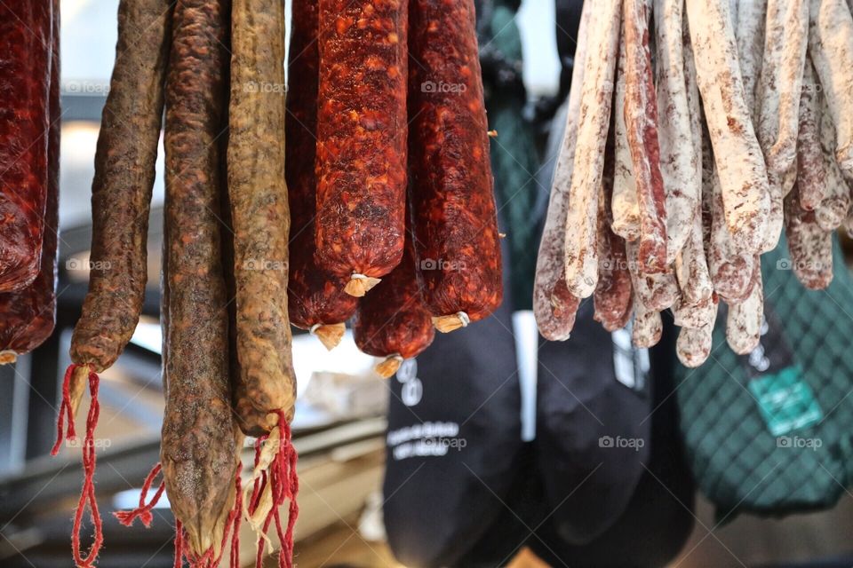 Three different Sausages hanging from the roof 