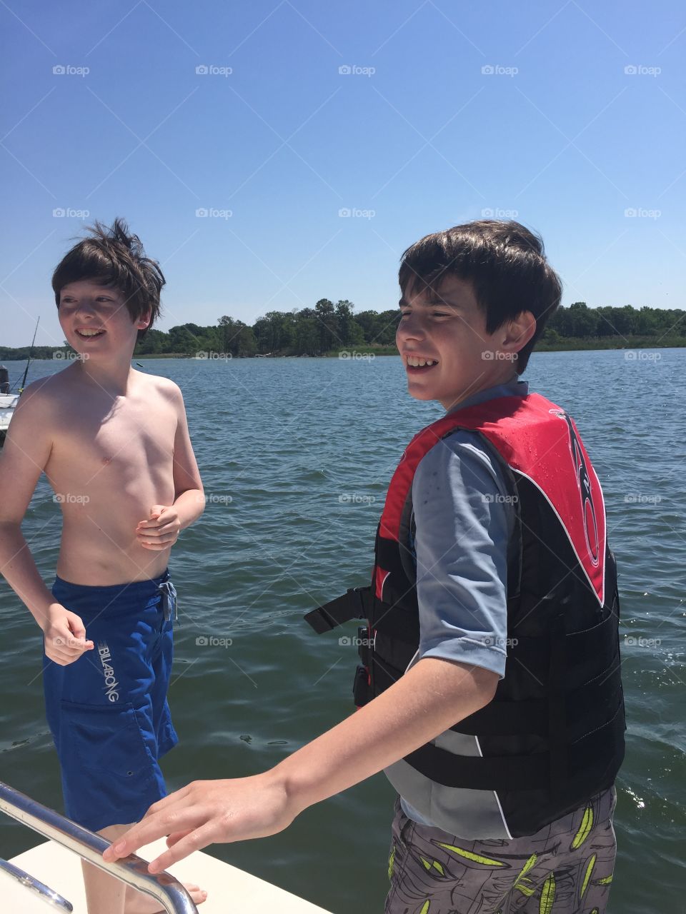 Boys sun water boat smile 