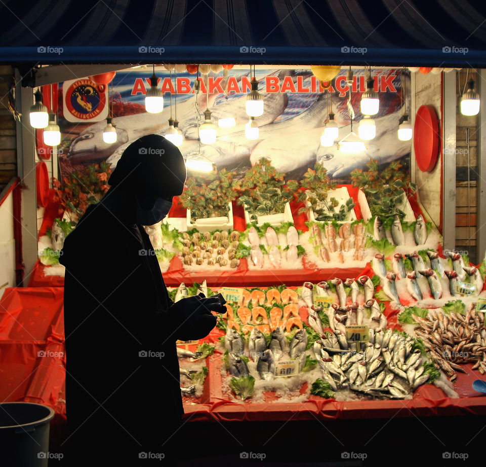 Walking with my friend at Ankara city. Suddenly I saw a clean silhouette of him while stopping in front of fish shop for texting with his cellphone. Instantly, I took some pictures of him.