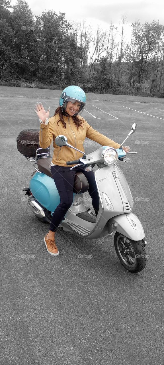 Waving Woman on Her Blue Scooter