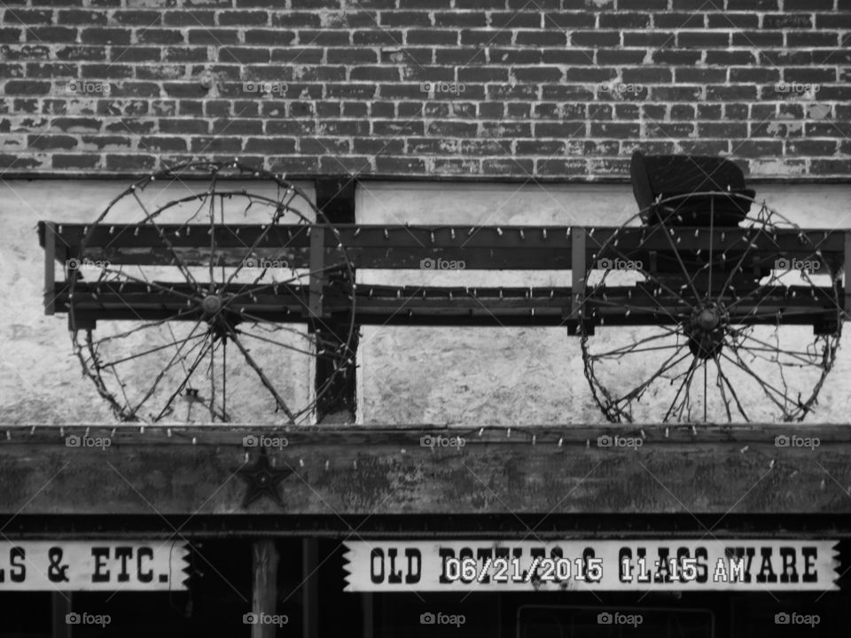 old wagon. This is a picture of a wagon that sits up on a awning in front of gift shop in Weatherford Texas