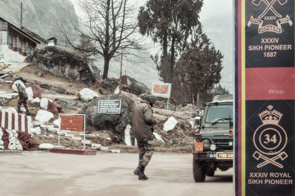 Nathu La, Sikkim, Jan 2019: An Indian BSF army major watches Indian post at a 14,500 Ft high mountain pass on "McMahon" line in Indo Nepal and Indo Bhutan border area on way through himalayan roads.