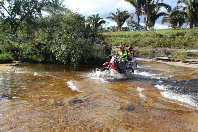Bikers doing trail in waterfall