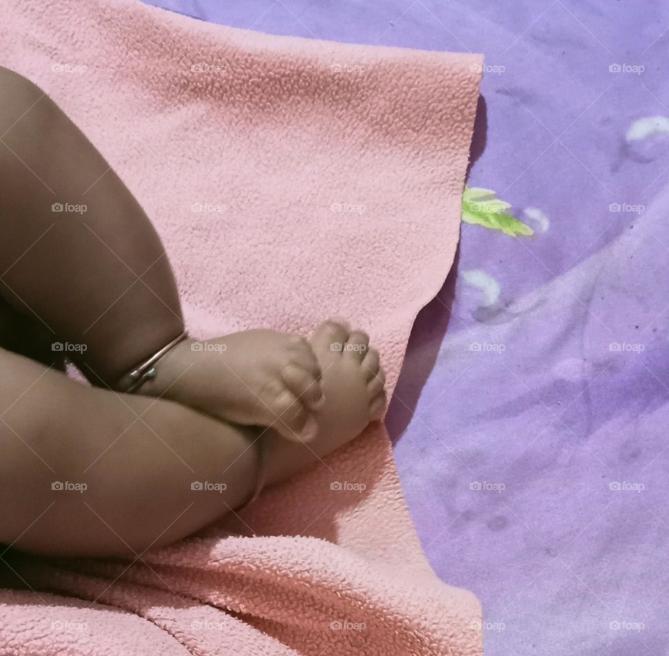 This beautiful ❤️😍 legs 🦵 of two months baby girl 🐥😍. Baby is sleeping in her bed and playing joyfully with her toys!!🪀🧸