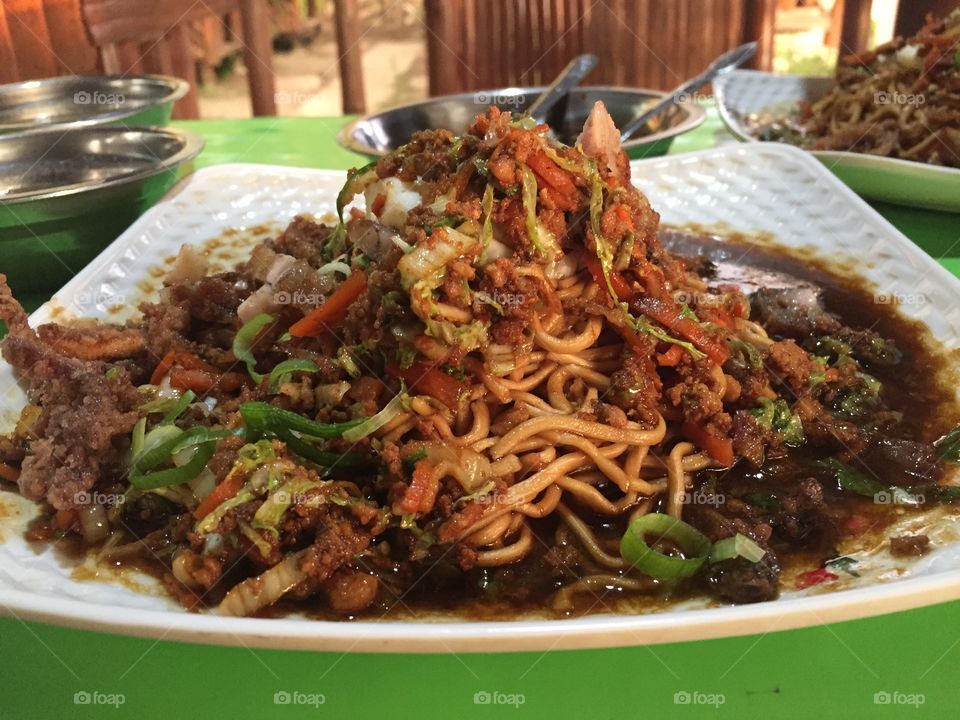Special Pancit Batil Patong! A must try delicacy in Tuguegarao, Philippines. It is composed of boiled handmade noodles plus meat, vegetable and fried squid served with a combination of soy sauce, onion and chilli. 