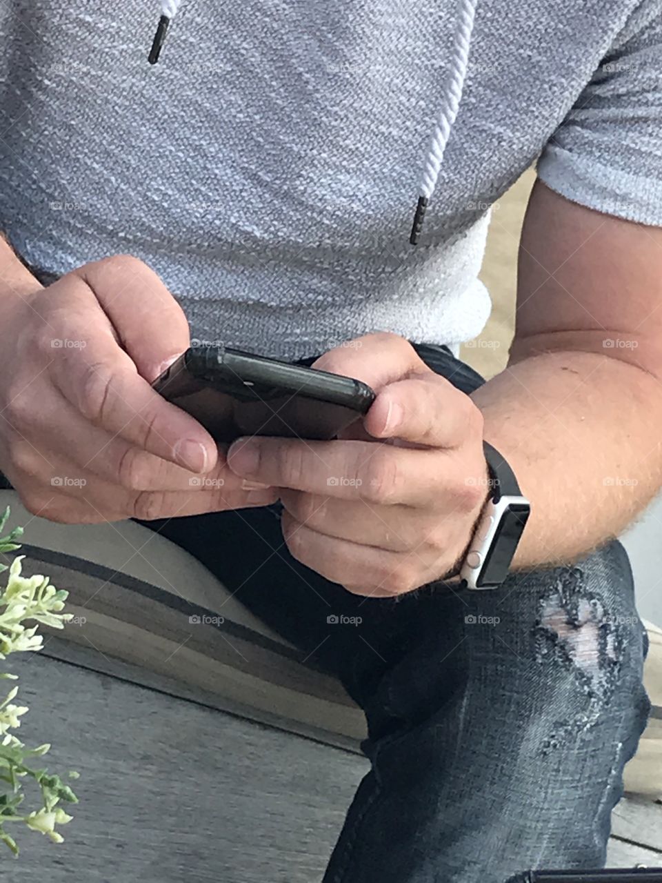 Man using iPhone and Apple Watch 