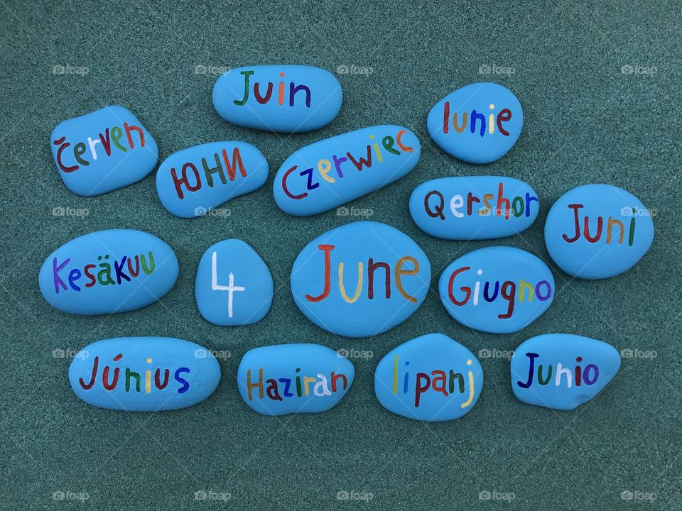 4 June, calendar date with colored stones over green sand