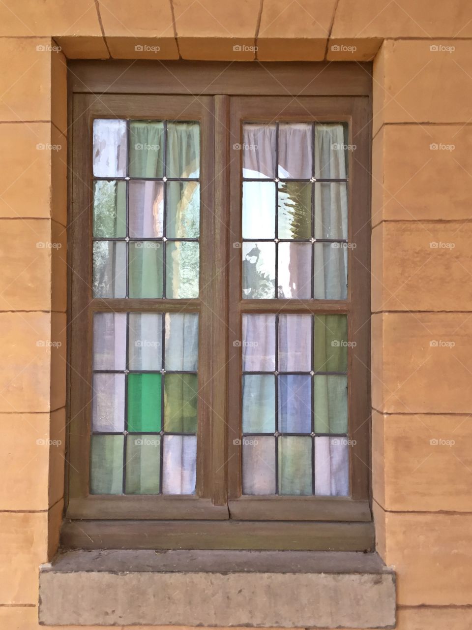 Stained glass window. Framing the photo draws focus to the subject in the photo by blocking other parts of the image with something in the scene