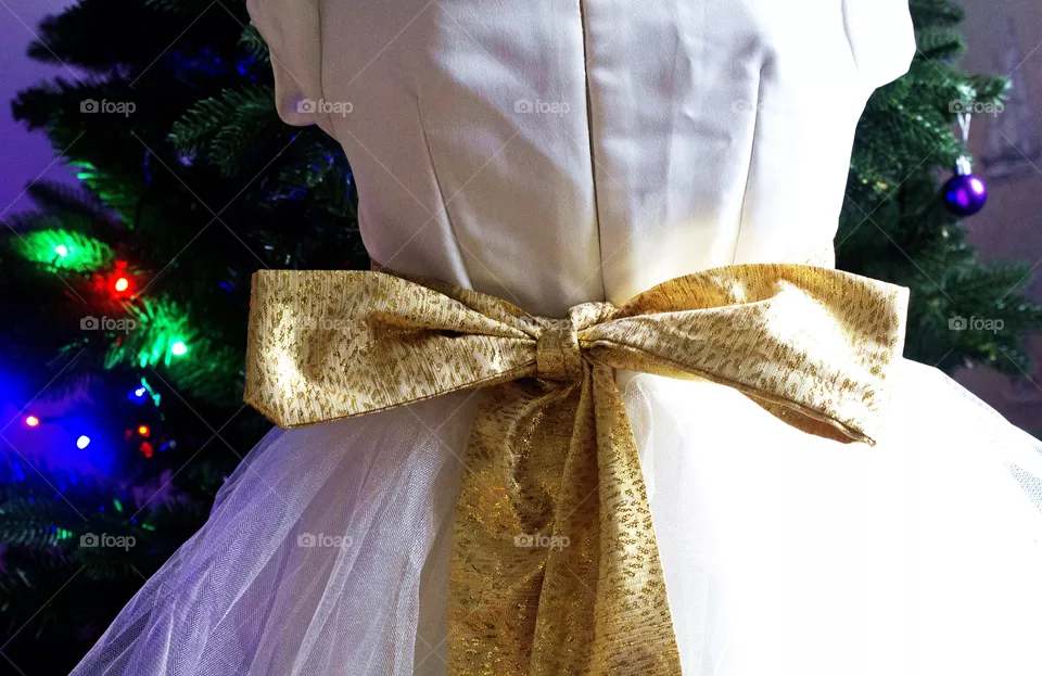Ribbons on girl's dress.