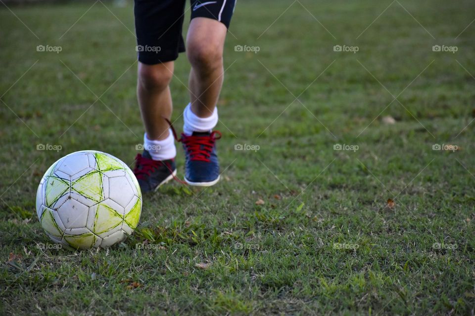 boy playing soccer