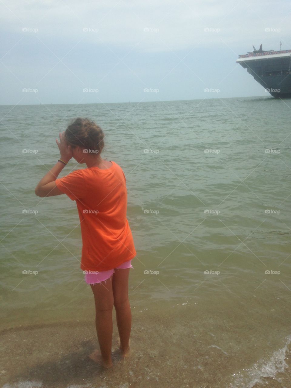 A girl looks to the ocean 