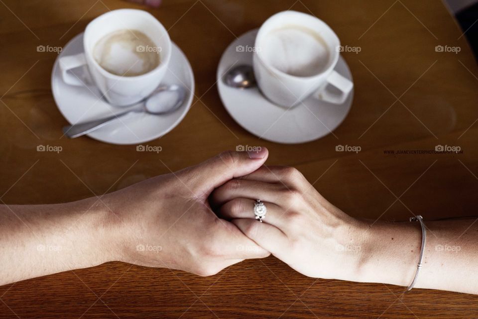 Couple holding hands in cafe