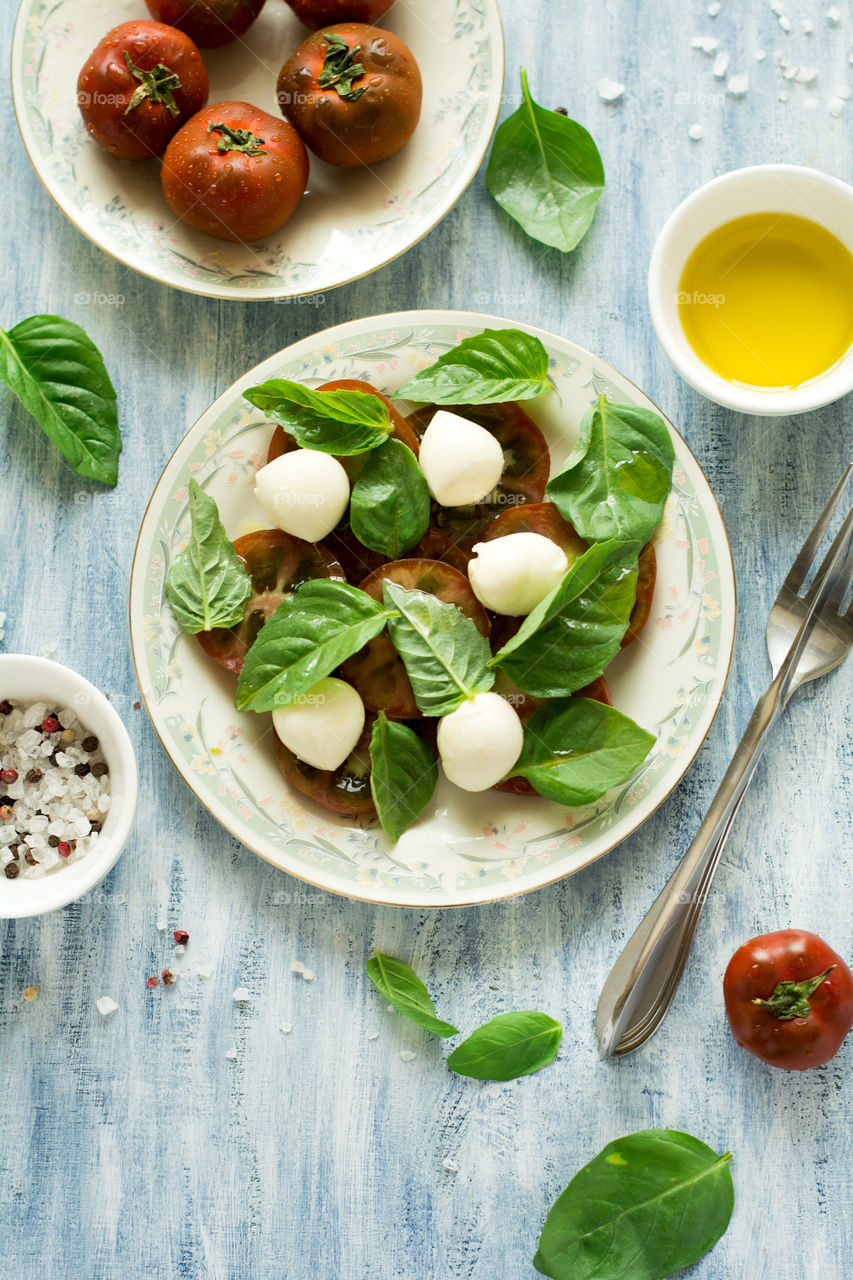 Fresh salad with tomato, mini mozarella and basil