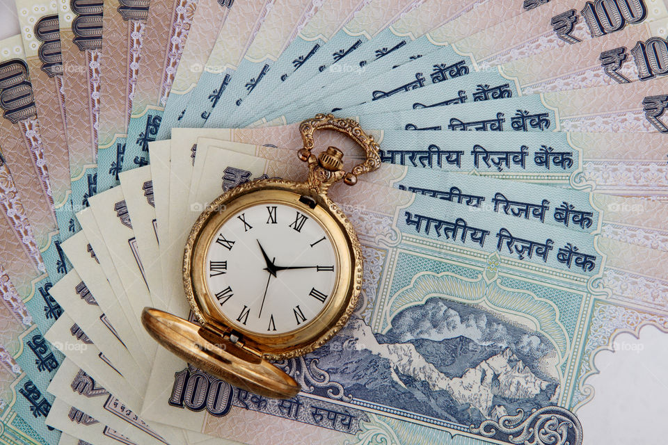 Antique watch on Indian rupee