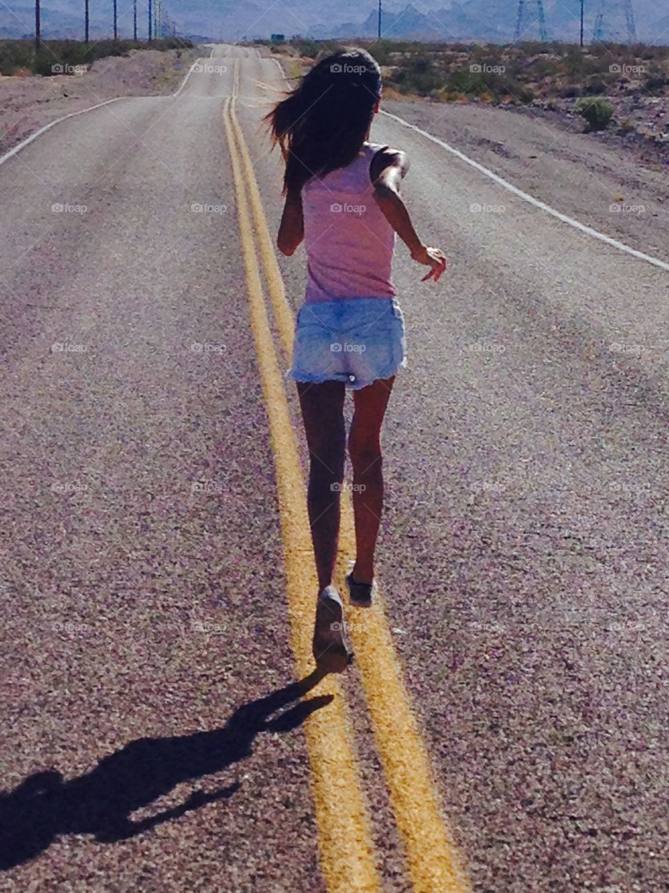 Woman is running on the route 66 to Oatman