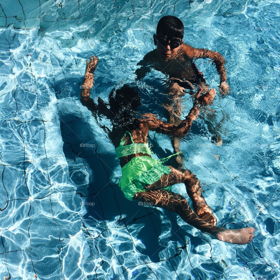 Brother and sister enjoying underwater