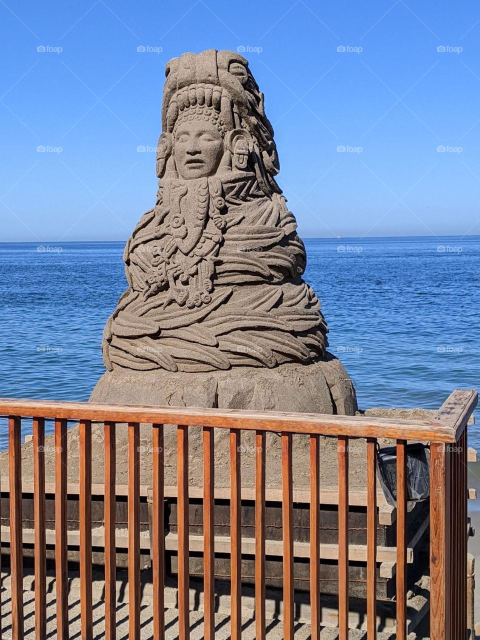 Mayan statue sculpted out of sand, sand castle, architectural beauty made on the shoreline of Mexico