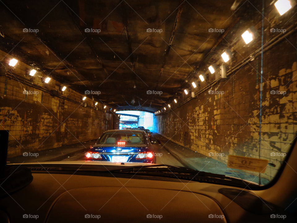 Driving through old stone underground tunnel up into the daylight.