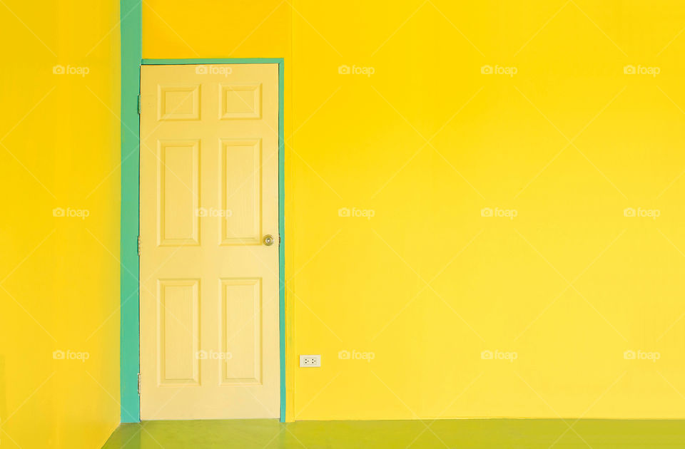 yellow door and green pillar in the yellow room