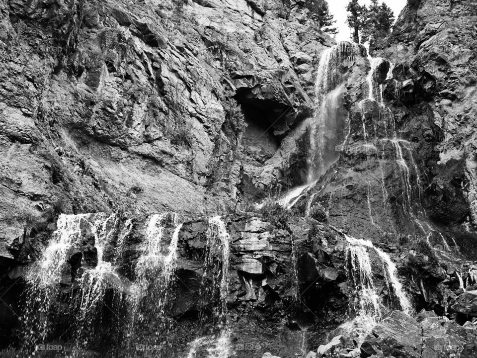 Cascading mountain waterfall in black and white