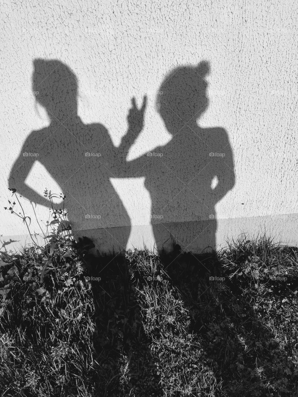 two woman's shadows, female friends black and white background