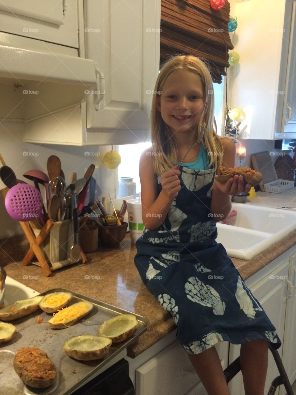 Little girl helping cook in the kitchen 