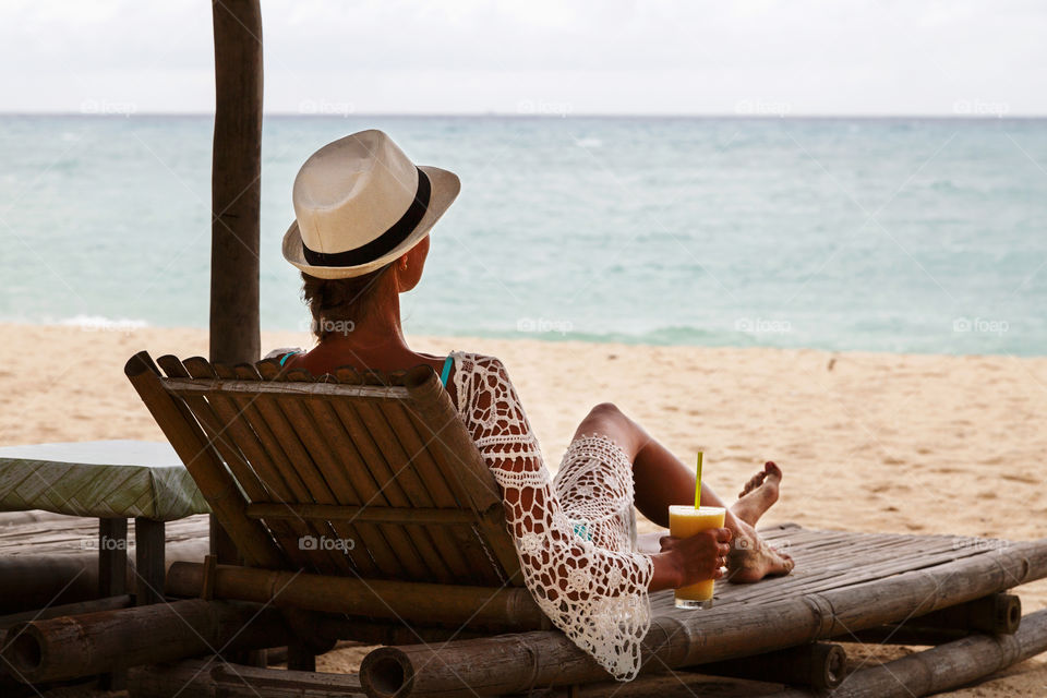 Woman relaxing on lounger on the beach 