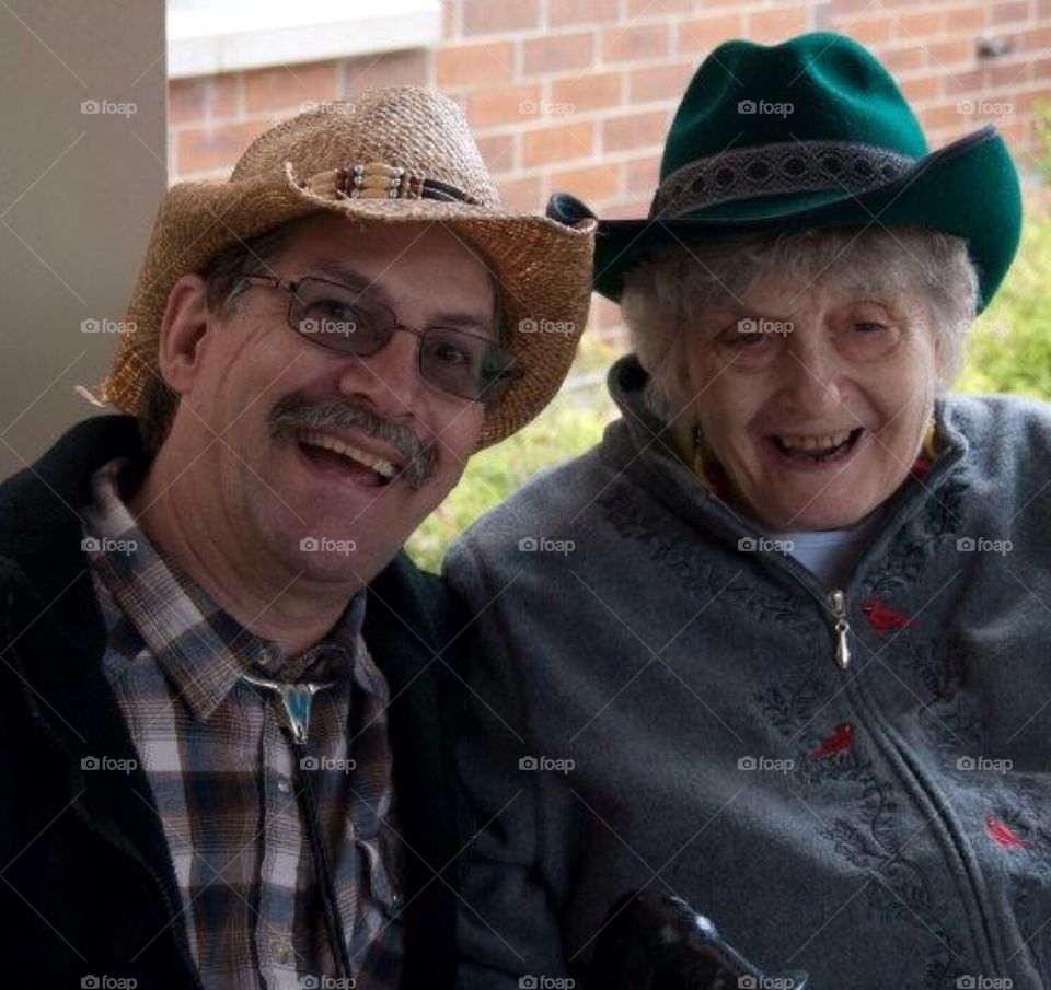 Senior citizen : western days. Son with mother at a western days activity , senior assistive living center.