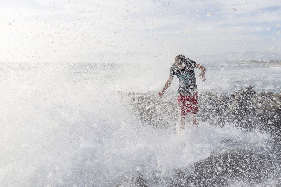 Pacific waves smash against the rocks at Venice beach, California 