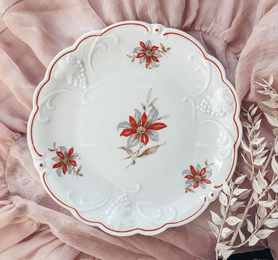 Vintage porcelain plate with reliefs and florals 