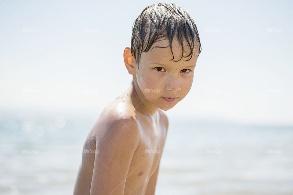 Close-up of a wet shirtless boy
