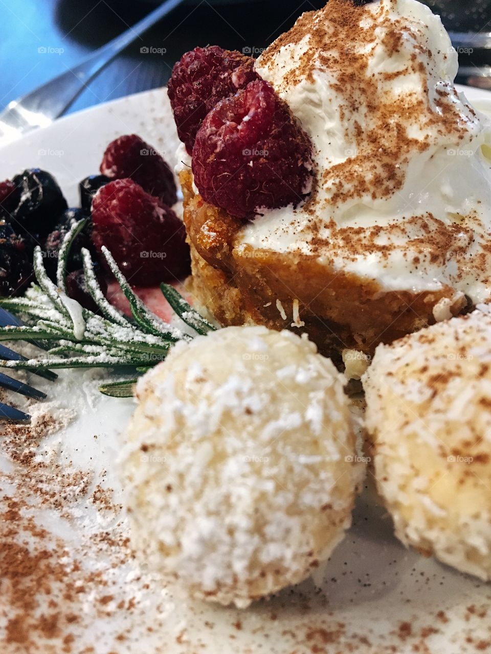 Closeup shot of a delicious desert with raspberrys and coconut candies 