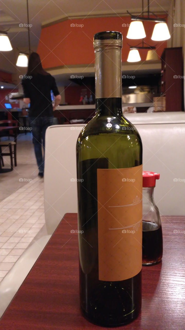 A bottle of wine in the french restaurant on a romantic dating