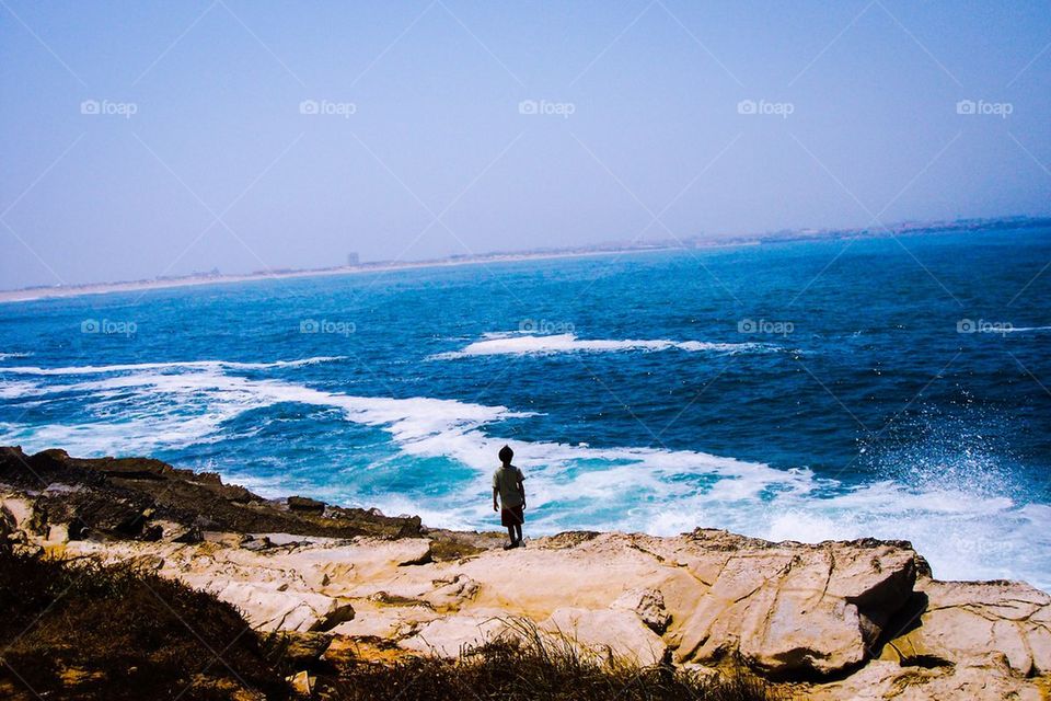 Child standing on rock