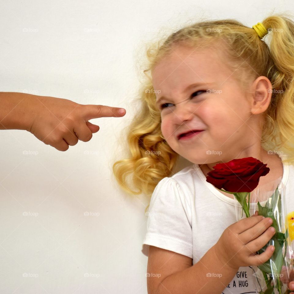 Cute girl holding red rose in hand