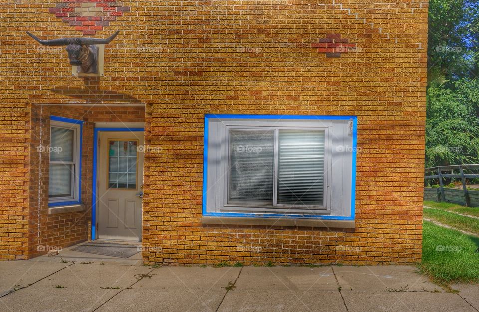 Brick Facade. Longhorn Above Door