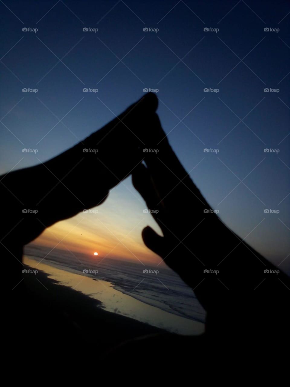 beautiful sunset trough hands.