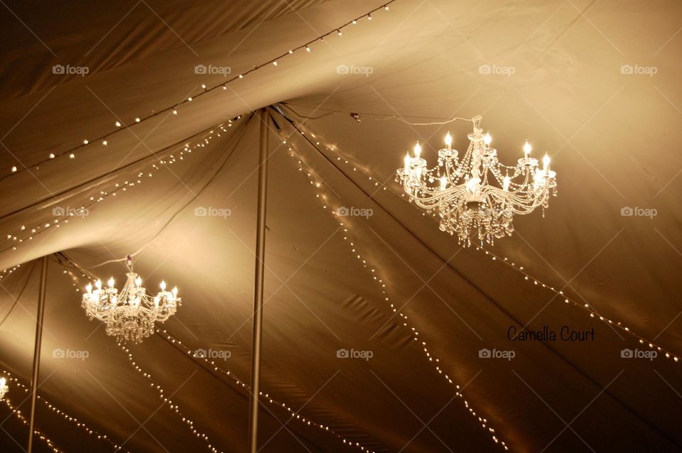 Chandeliers hanging in a reception tent