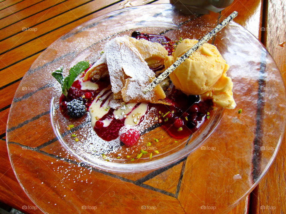 Food on a plate. dessert - strudel with fruit and icecream