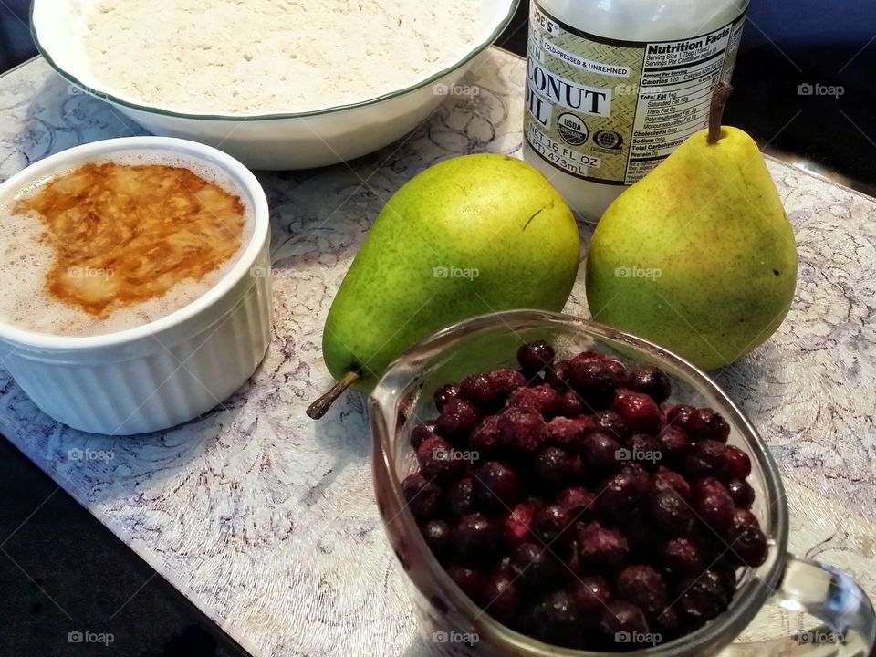 The makings for old fashioned blueberry pear cobbler on a cutting board