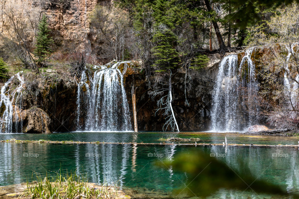 Beautiful crystal clear water flowing from a waterfall into a Colorado lake high in the mountains. 