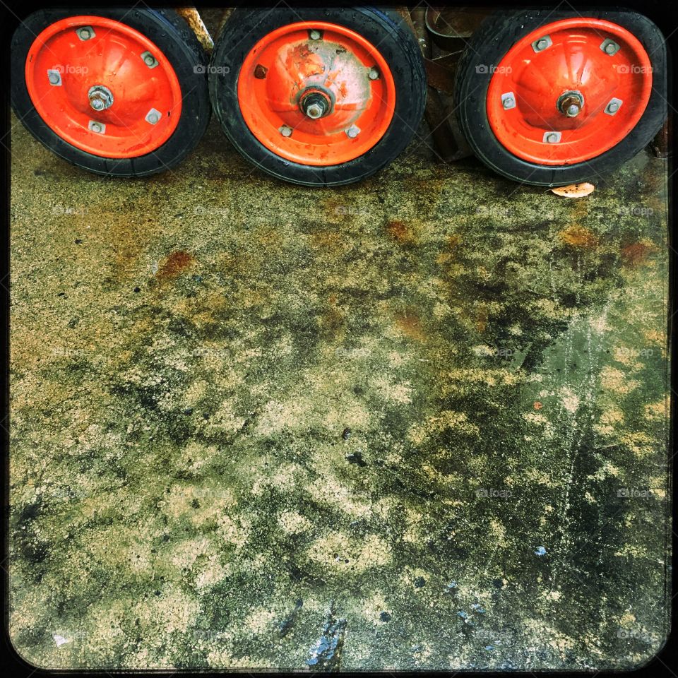 Red wheels on wet concrete 