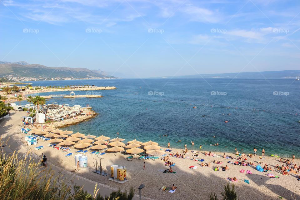 Panoramic view of beautiful beach with chairs and umbrellas and crystal clean sea