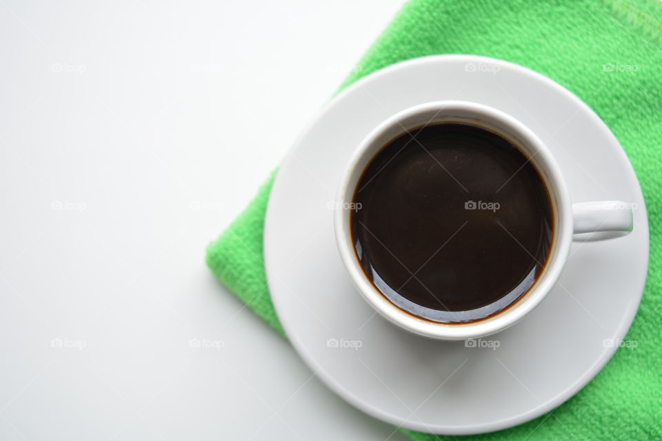 coffee cup top view on a white and green background