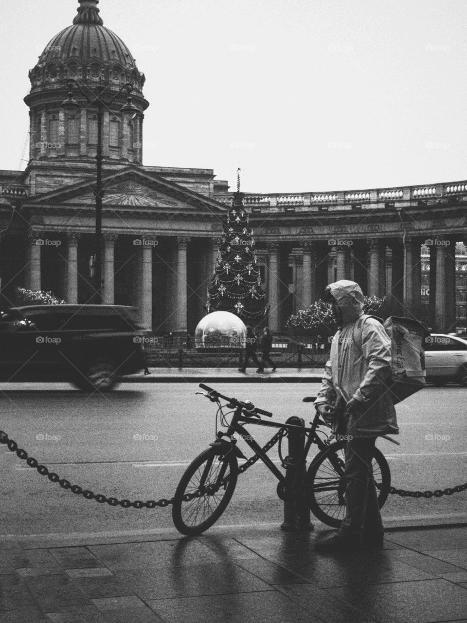 Lonely delivery boy is standing in the rain  