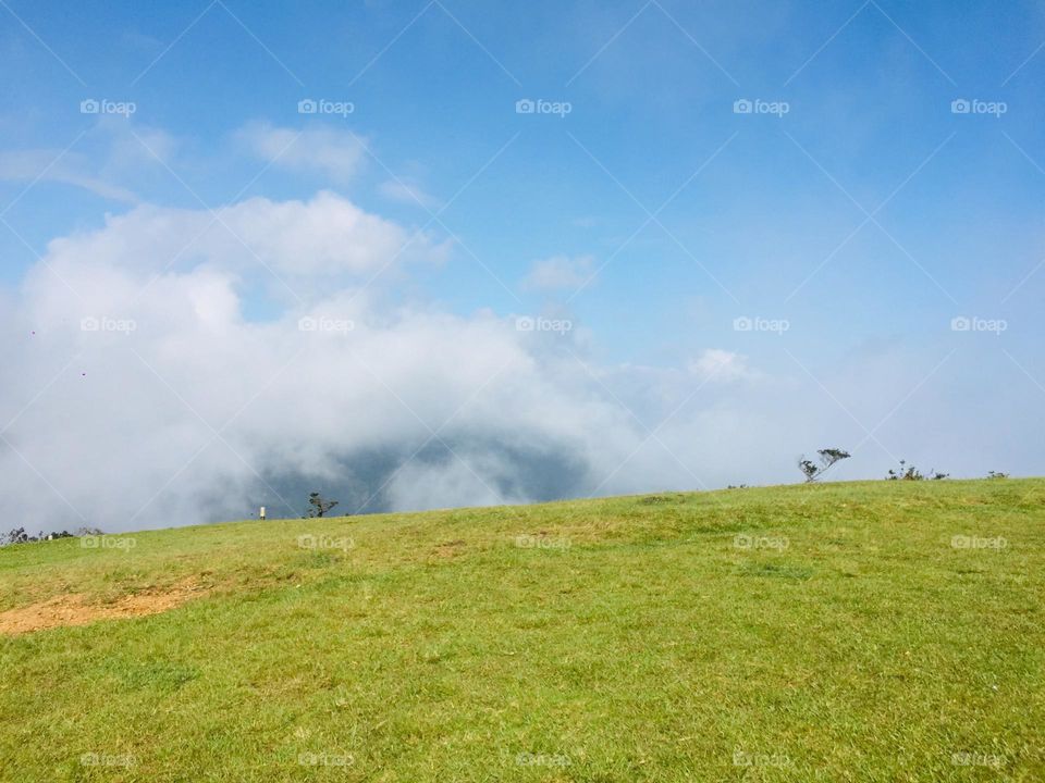 A top of the mountain with blue sky and cloudy