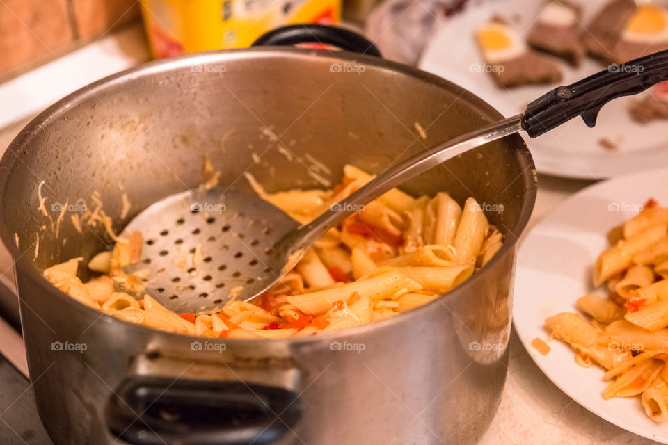 Cooking Penne Pasta Macaroni With Tomato Sauce In A Pot
